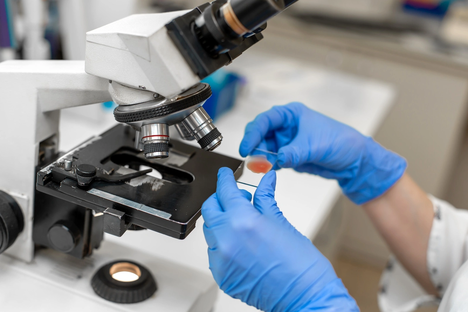 Microscope in medical lab with blood smear on glass slide