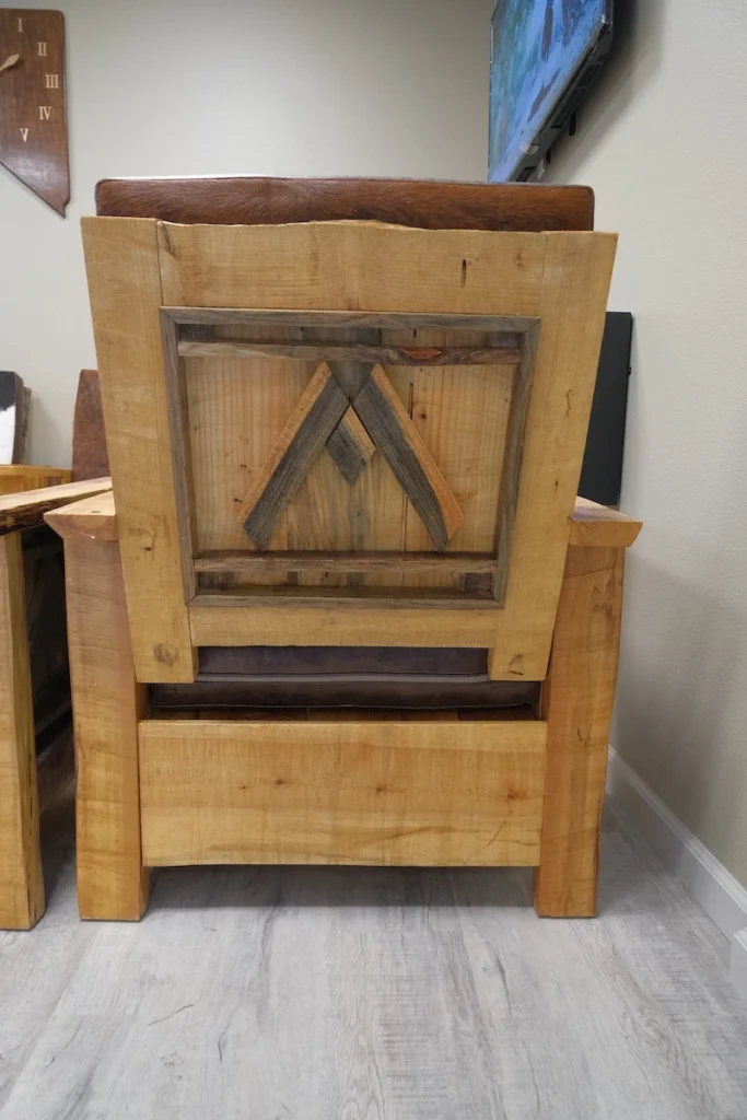 Adirondack style chair back view with appealing Mountain Medical logo burnt wood outlay design