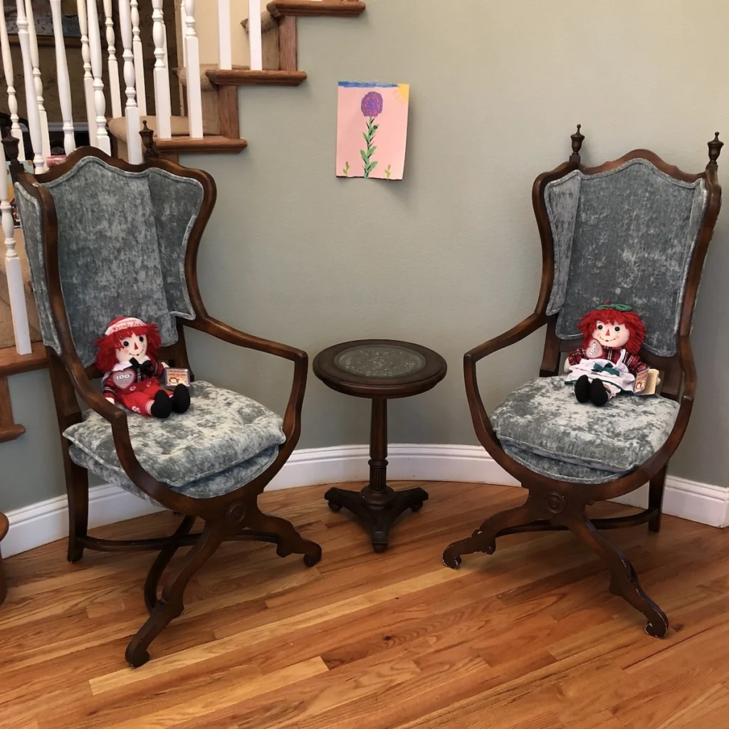 A pair of antique French gothic style arm chairs reupholstered in sky blue velvet