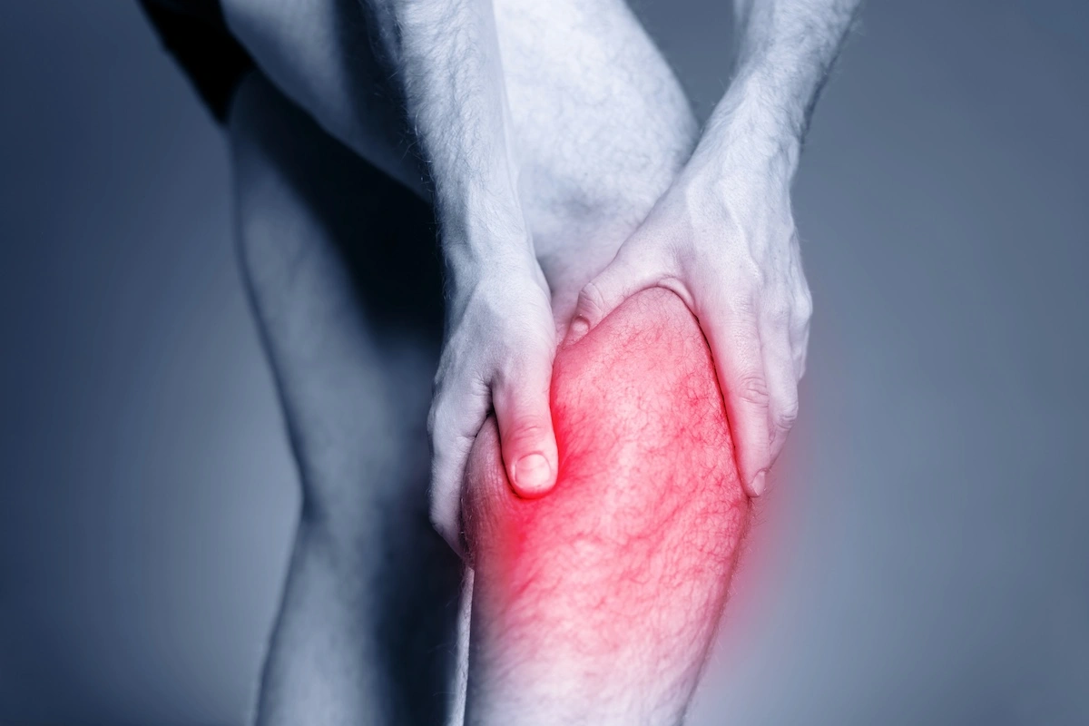 Male clutching calf muscles in pain