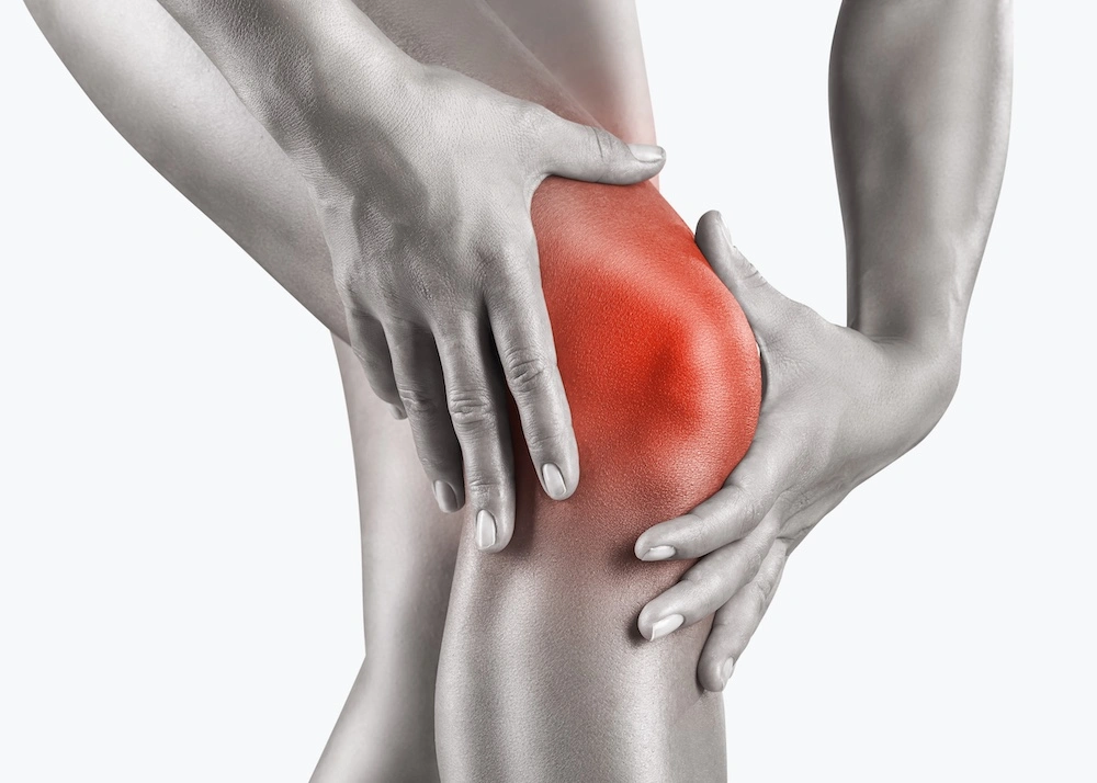 Female clutching painful knee